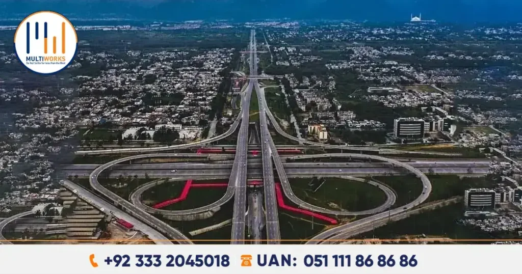 An aerial view of a large multi-lane interchange in Islamabad, surrounded by urban landscapes and greenery, highlighting advanced infrastructure development in Pakistan.