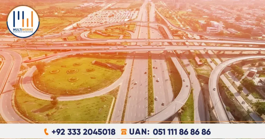 Aerial view of Jinnah Avenue Interchange flyover in Islamabad, featuring modern infrastructure with multiple lanes, U-turns, and landscaped surroundings.
