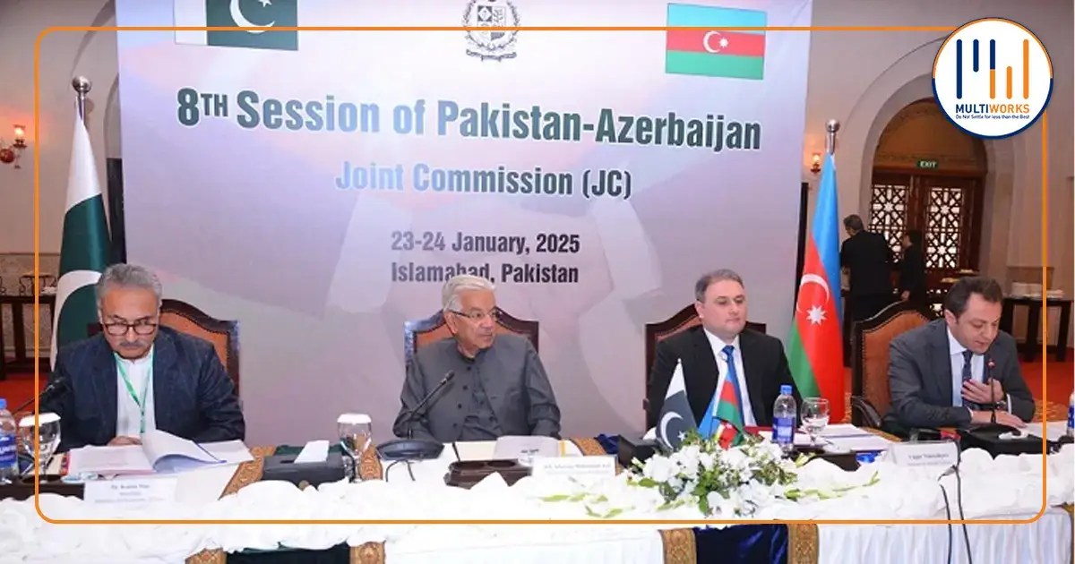 Pakistani and Azerbaijani officials sitting at the 8th Joint Commission session table in Islamabad, discussing bilateral agreements in trade, energy, and defense