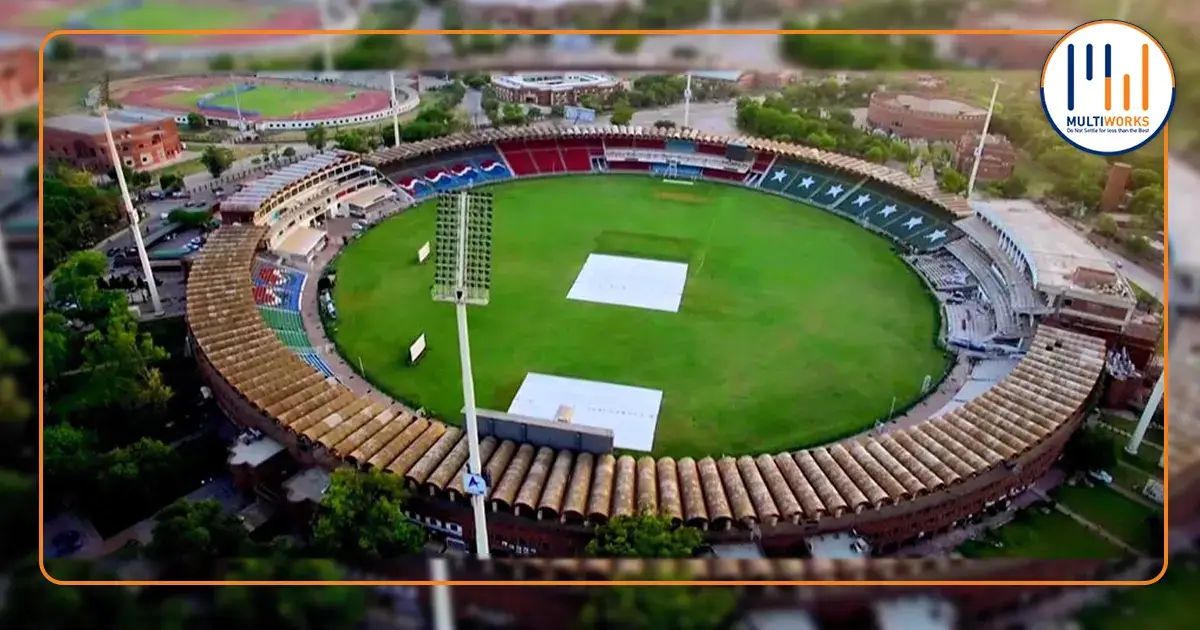 Aerial view of a modern cricket stadium with expansive seating and lush green ground, representing Islamabad’s new cricket stadium project.